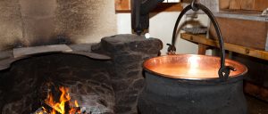 a cauldron by the cooking fire