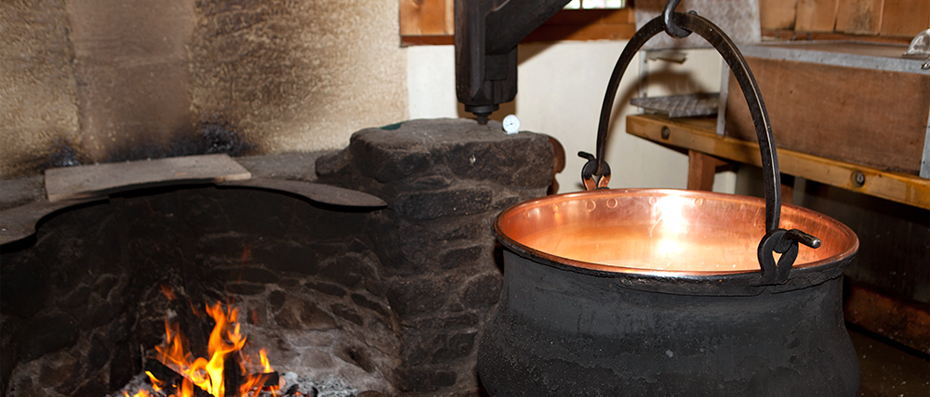 A cauldron next to the cooking fire.